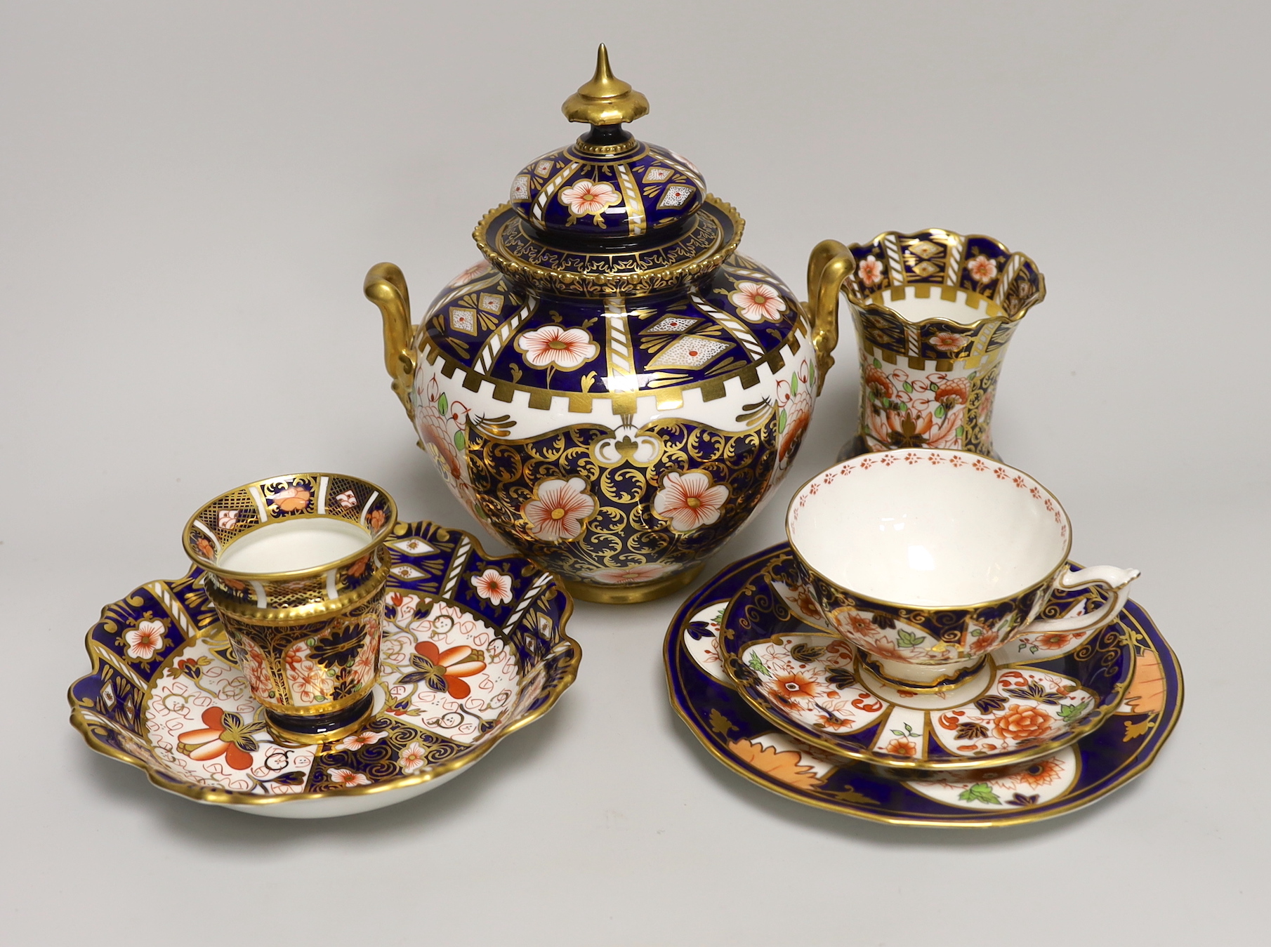 Seven pieces of Royal Crown Derby Imari porcelain including a trio and twin handled jar and cover, the largest 21cm high